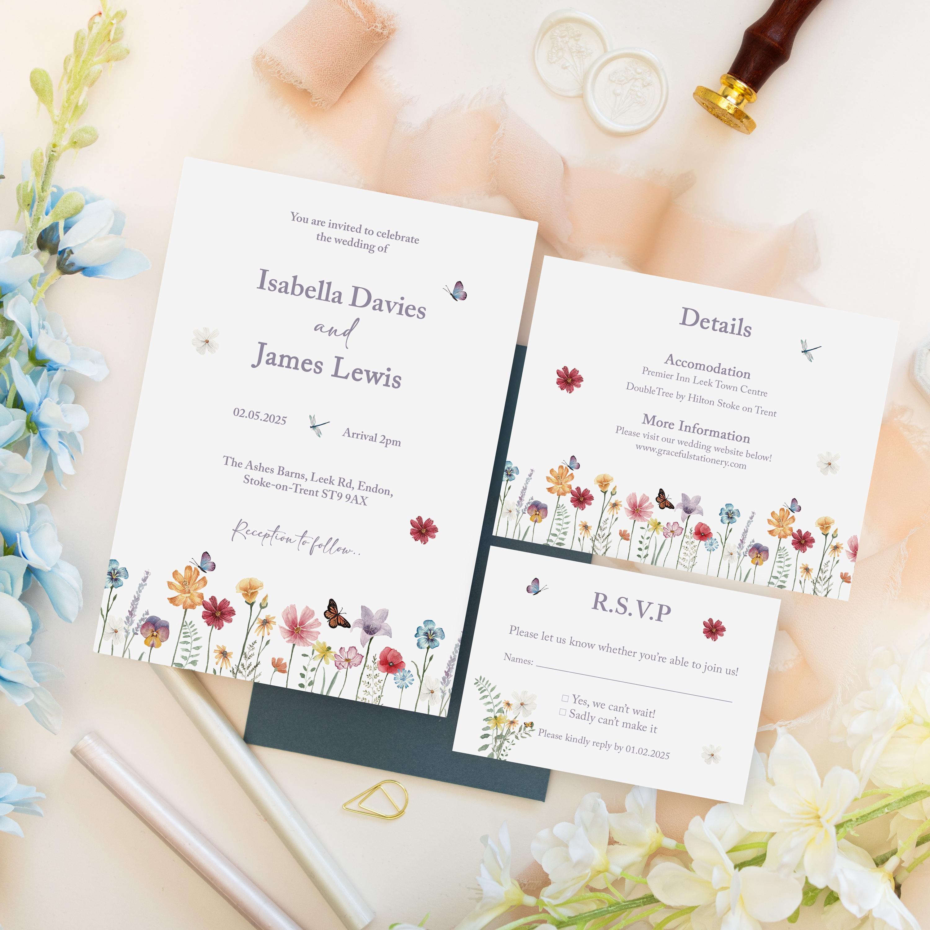 Wildflower wedding invitation for Isabella Davies and James Lewis with a Details card listing accommodation and website, and an RSVP card with Yes, we can’t wait and Sadly can’t make it options, on a dark envelope